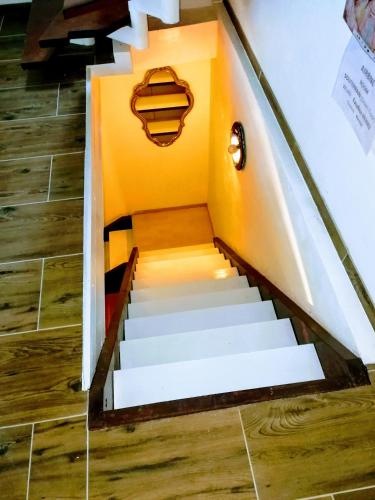 a set of stairs with yellow walls and wooden floors at WOHLFÜHLOASE - Zimmer, Appartment - im Herzen STARNBERGS in Starnberg