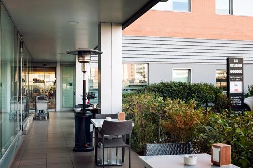 a patio with chairs and a table in front of a building at Ibis Budget Lleida in Lleida