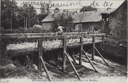an old photo of a man sitting on a bridge at Ilot du Moulin in Mordelles