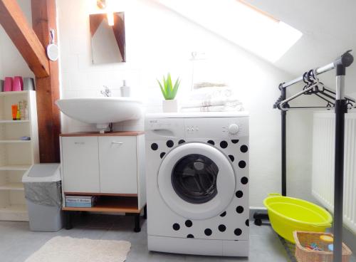 a washing machine in a bathroom with a sink at Apartmán Castle view in Český Krumlov