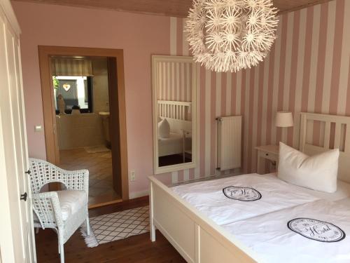 a bedroom with a bed and a chandelier at Ferienhaus Elbblick in Tangermünde