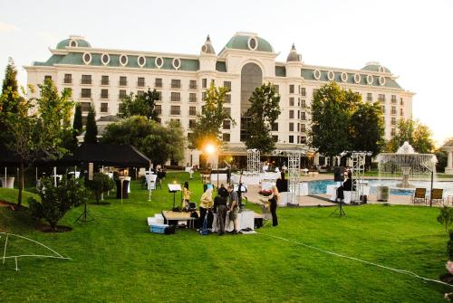 a group of people standing in a field in front of a building at Peermont D'oreale Grande at Emperors Palace in Kempton Park