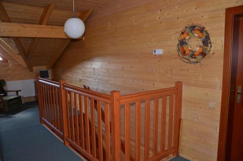 a room with a wooden wall with a wreath on it at Penzion Haltmar in Ostružná