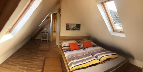 a bed in a room with two windows at Villawöl in Munich