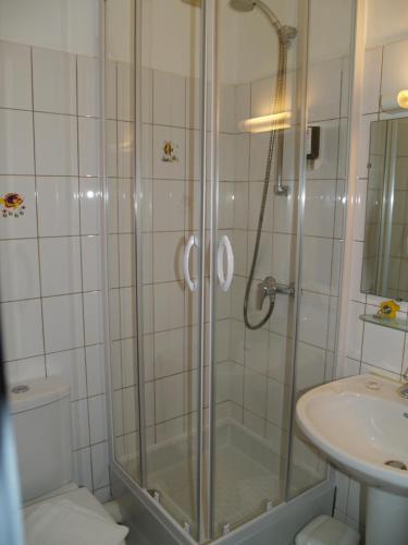 a bathroom with a shower and a sink at Le Relais Vauban in Abbeville