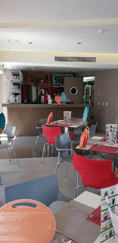 a restaurant with tables and chairs and a kitchen at Hotel Amala in Mexico City