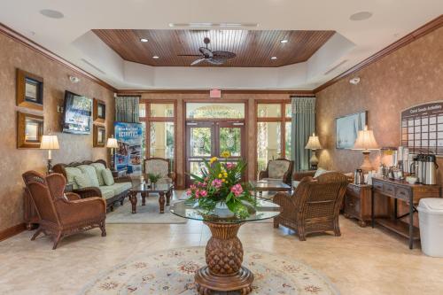 a living room with a table with flowers on it at Coral Sands Resort by Palmera in Hilton Head Island