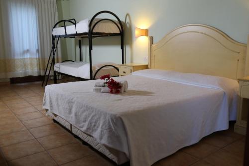 a bedroom with a bed with two bunk beds at Club Esse Cala Gonone in Cala Gonone