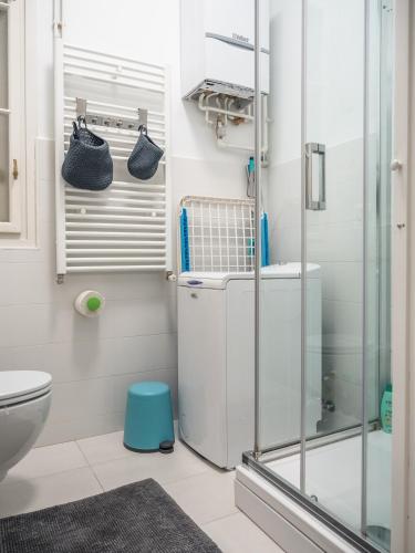a bathroom with a glass shower and a toilet at Artissimo Apartments in Zagreb