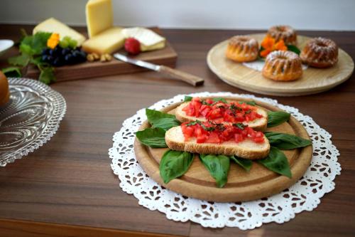 a table with a plate of food with sandwiches and muffins at Untermairhof B&B Christine in Lagundo