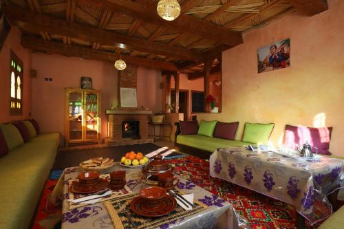 a living room with a couch and a table at Aroumd Authentic Lodge Managed By Rachid Jellah in Imlil