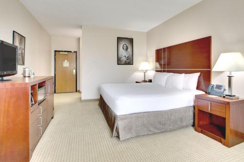 a hotel room with a bed and a television at Hollywood Casino Joliet Hotel in Joliet