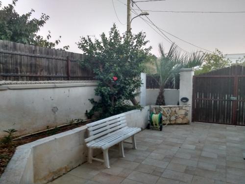 a bench sitting on a patio next to a fence at Villetta Simo in Capilungo