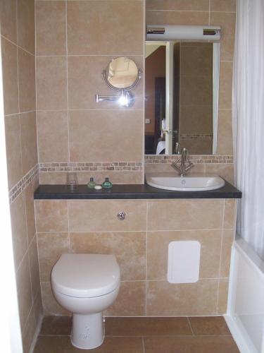a bathroom with a toilet and a sink at Columba Hotel Inverness by Compass Hospitality in Inverness