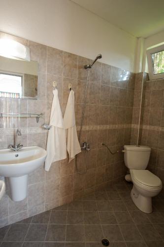a bathroom with a sink and a toilet at Guest House Gardeli in Tsarevo