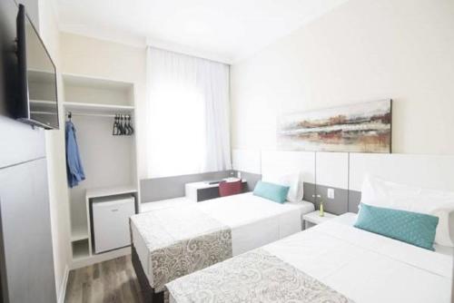 Ένα ή περισσότερα κρεβάτια σε δωμάτιο στο Hotel H2 Congonhas