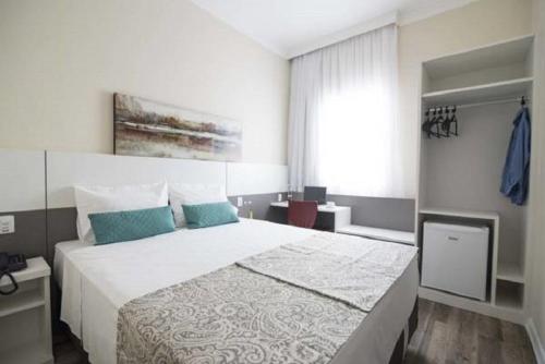 Postel nebo postele na pokoji v ubytování Hotel H2 Congonhas