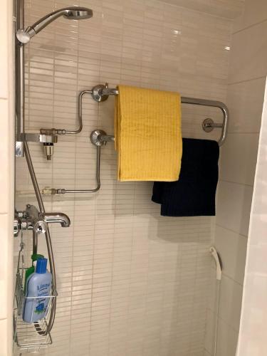 a bathroom with a yellow towel and a shower at Feels like Arctic City in Rovaniemi