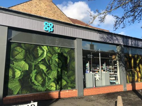 a store front with a mural of cabbage at Amazing London in London