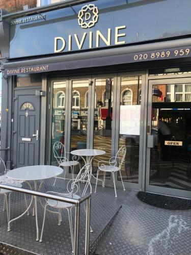 two tables and chairs in front of a wine restaurant at Amazing London in London
