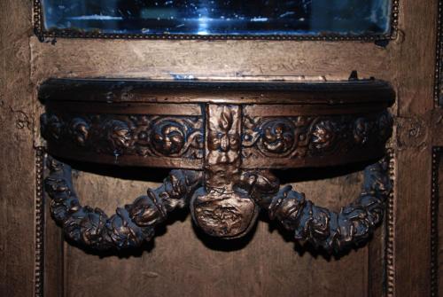 a wooden table with a mirror on a wall at Cecilia Hostel in Cairo