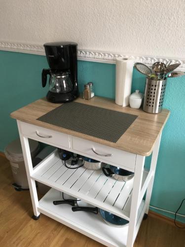 a table with a coffee maker on top of it at Apartment in der Innenstadt in Göttingen