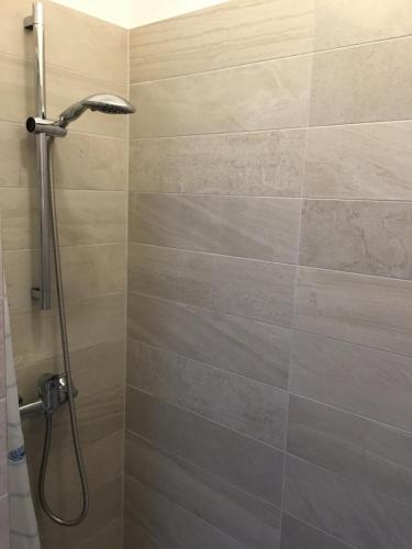 a shower with a shower head in a bathroom at Apartment in der Innenstadt in Göttingen