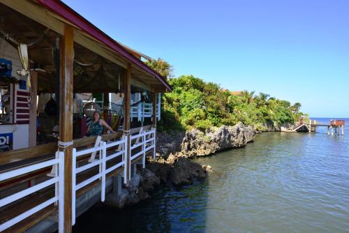 a person sitting on a boat in the water at Seagrape Plantation Resort & Dive Center in West End