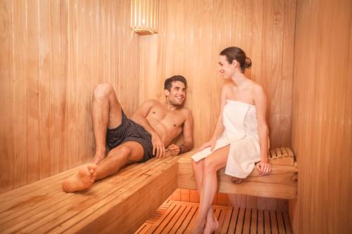 a man and a woman sitting in a sauna at Vichayito Bungalows & Carpas by Aranwa Hotels in Vichayito