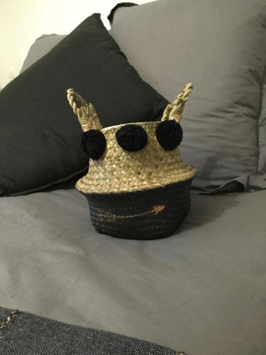 a crocheted purse is sitting on a bed at La Maison des Eaux Claires in Puymoyen