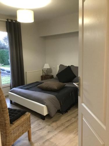 a bedroom with a bed and a window at La Maison des Eaux Claires in Puymoyen