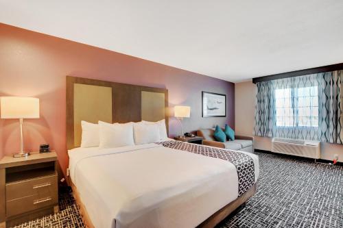 a hotel room with a large bed and a window at La Quinta Inn & Suites by Wyndham Las Vegas Nellis in Las Vegas