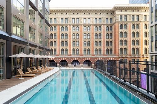 a large swimming pool in front of a building at ROOST East Market in Philadelphia