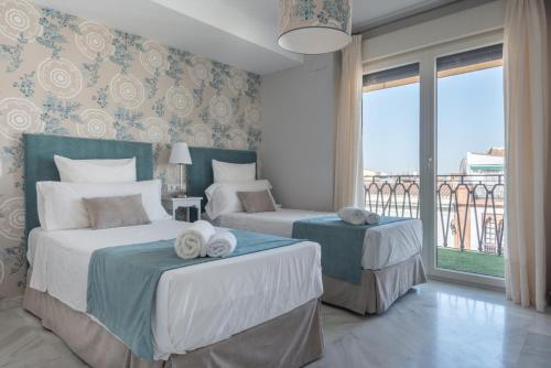 A bed or beds in a room at BeHouse Avenida