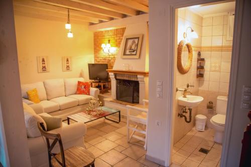 a living room with a couch and a fireplace at Traditional House in the Centre of Vasiliki in Vasiliki