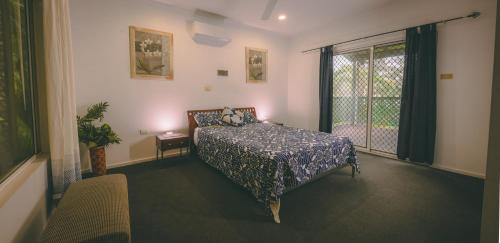 a bedroom with a bed and a window at Darwin House in Palmerston