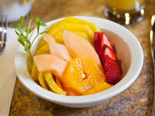 a white bowl filled with fruit on a table at Wyoming Inn of Jackson Hole in Jackson