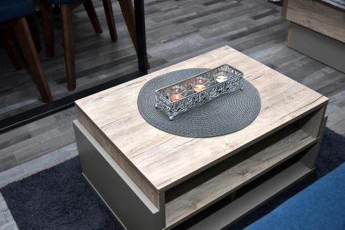 a wooden table with a hat on top of it at Apartman Sladjana Premier 12 Milmari in Kopaonik