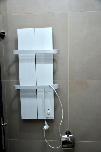 a bathroom with white shelves on a wall at Apartman Sladjana Premier 12 Milmari in Kopaonik