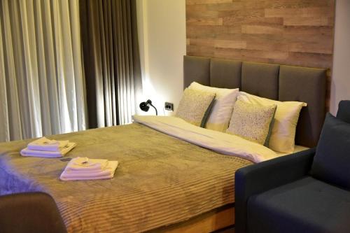 a bedroom with a bed with two towels on it at Apartman Sladjana Premier 12 Milmari in Kopaonik