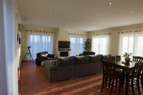 a living room with a couch and a table at Vivenda da Saudade B&B in Angra do Heroísmo