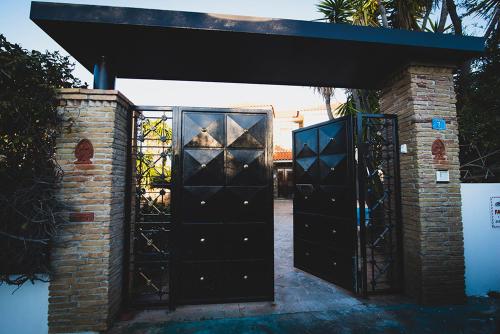 an entrance to a house with a black gate at Villa Soula in Anavissos