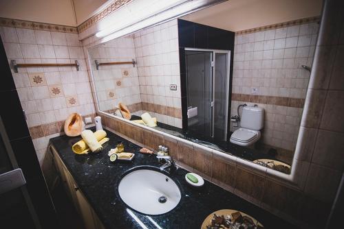 a bathroom with a sink and a mirror at Villa Soula in Anavissos