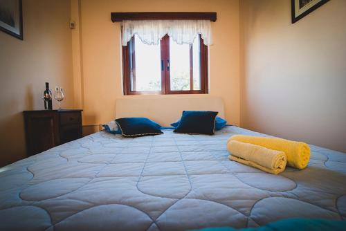 a large blue bed in a room with a window at Villa Soula in Anavissos