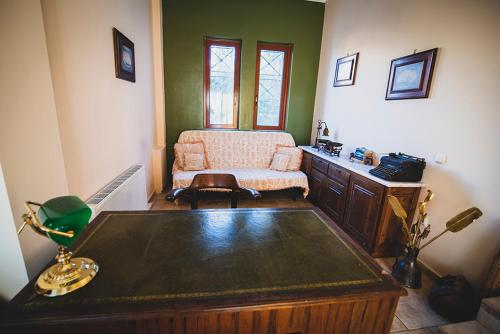 a living room with a table and a chair at Villa Soula in Anavissos