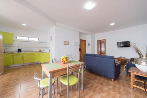 a kitchen and living room with a table and chairs at Apartamentosánchez in Vecindario