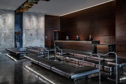 a waiting room with leather chairs and a bar at Palms Place Hotel and Spa in Las Vegas