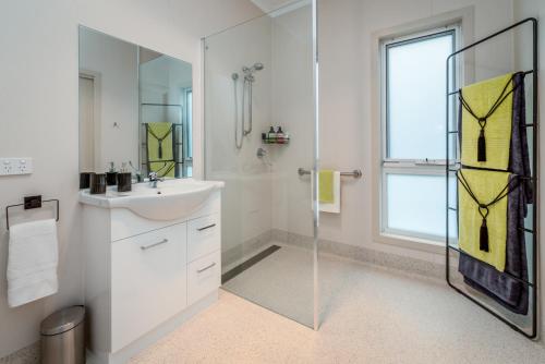 a white bathroom with a sink and a shower at Erriba House in Erriba