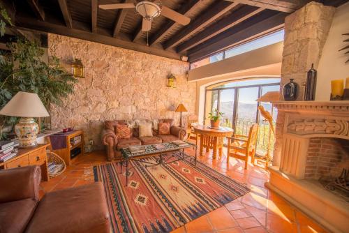 a living room with a couch and a fireplace at Casa Estrella de la Valenciana Hotel Boutique in Guanajuato