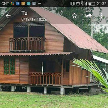 a small wooden house with a balcony on top of it at QUINTA PRIMAVERA - Hostería Campestre in Nueva Loja